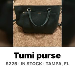 it is a dark green tumi purse